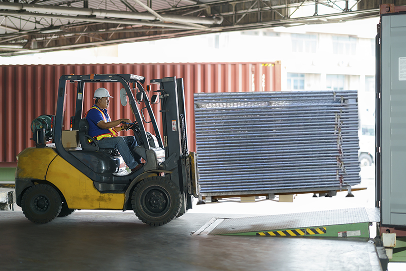 Forklift carrying multiple temporary fence panels at once