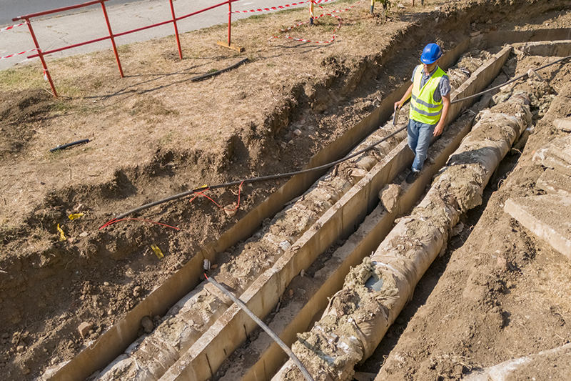 men working on a trench