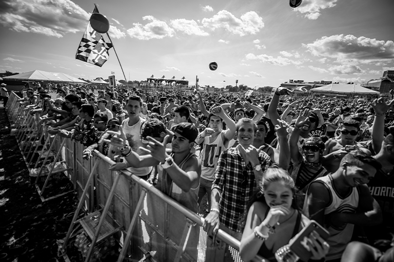 People at a concert standing at the stage barrier