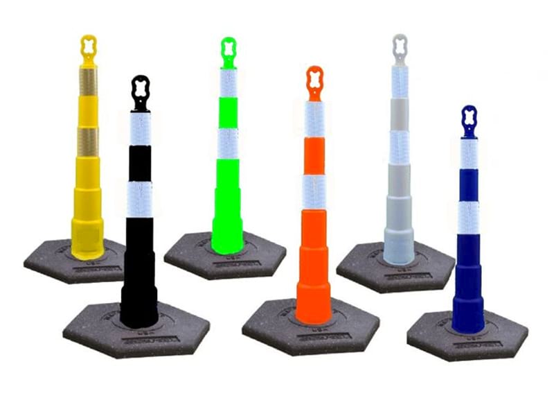 Different types of delineator posts in multiple colors including yellow, orange and blue with reflective bands and rubber bases.